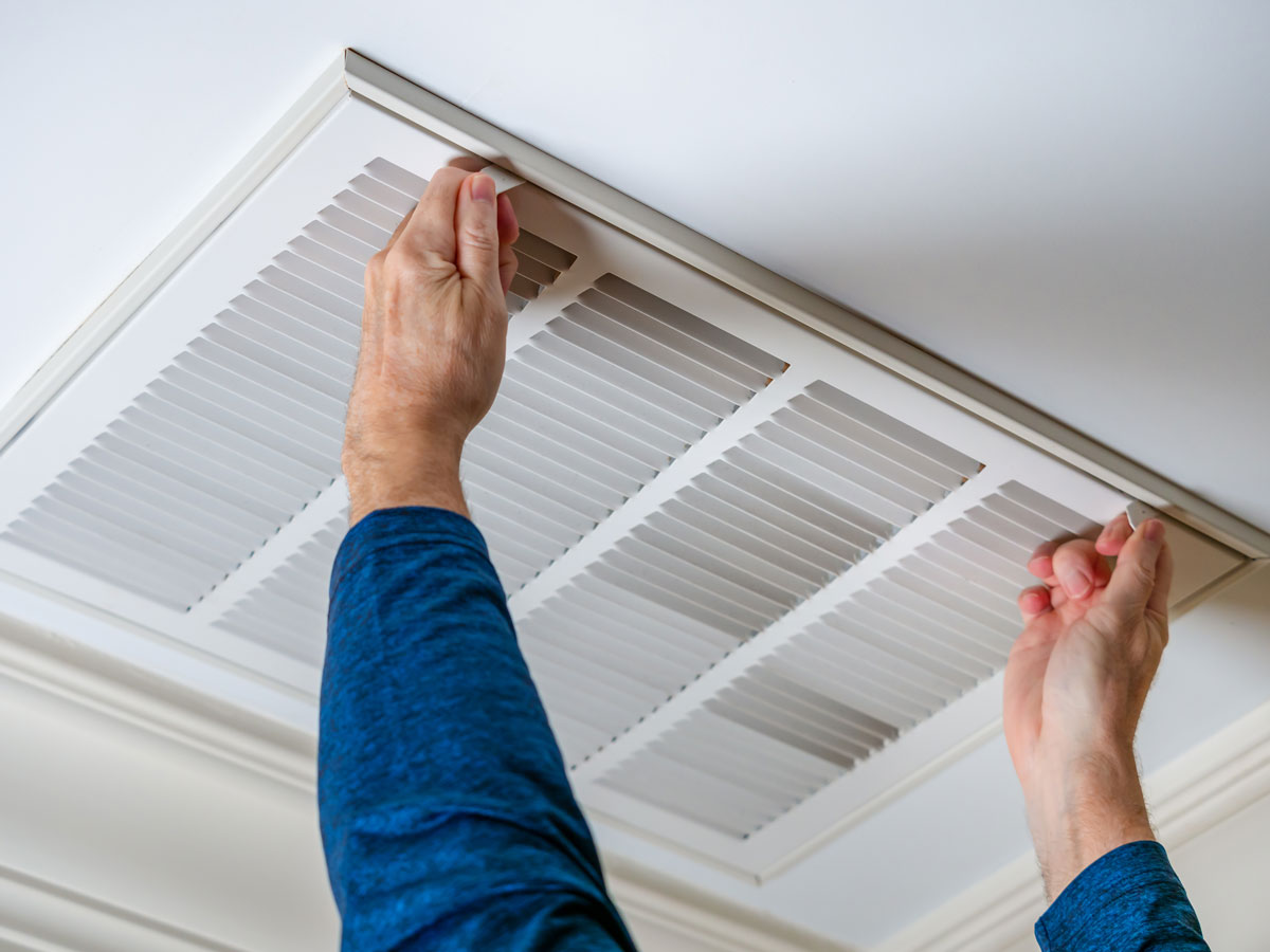 Hands opening air vent cover