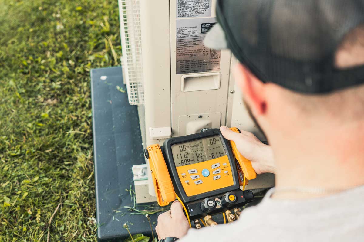 Heating repair technician using tool
