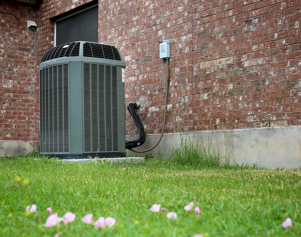 Outdoor AC unit beside house